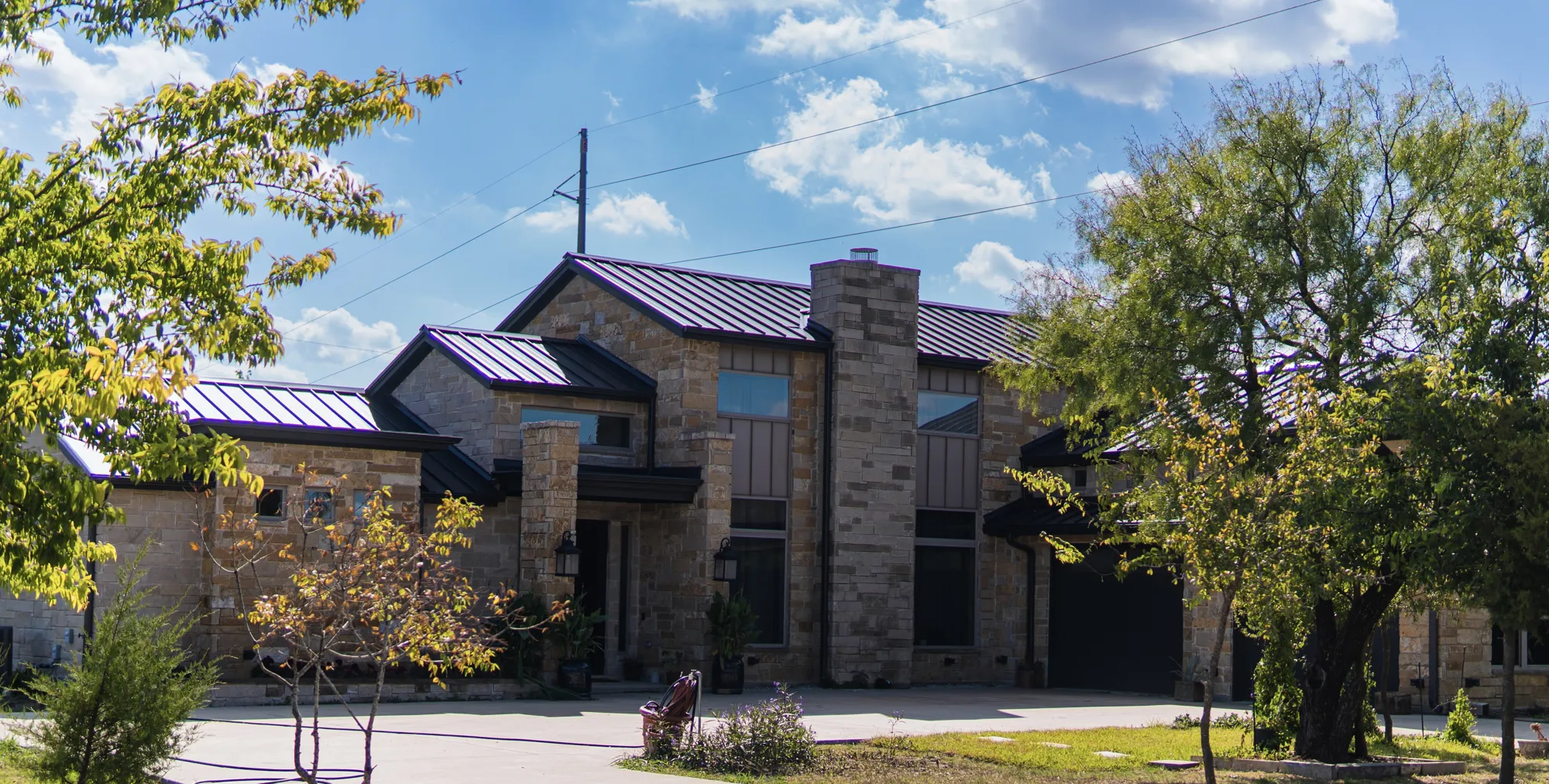 Stone custom home with metal roof in Fort Worth
