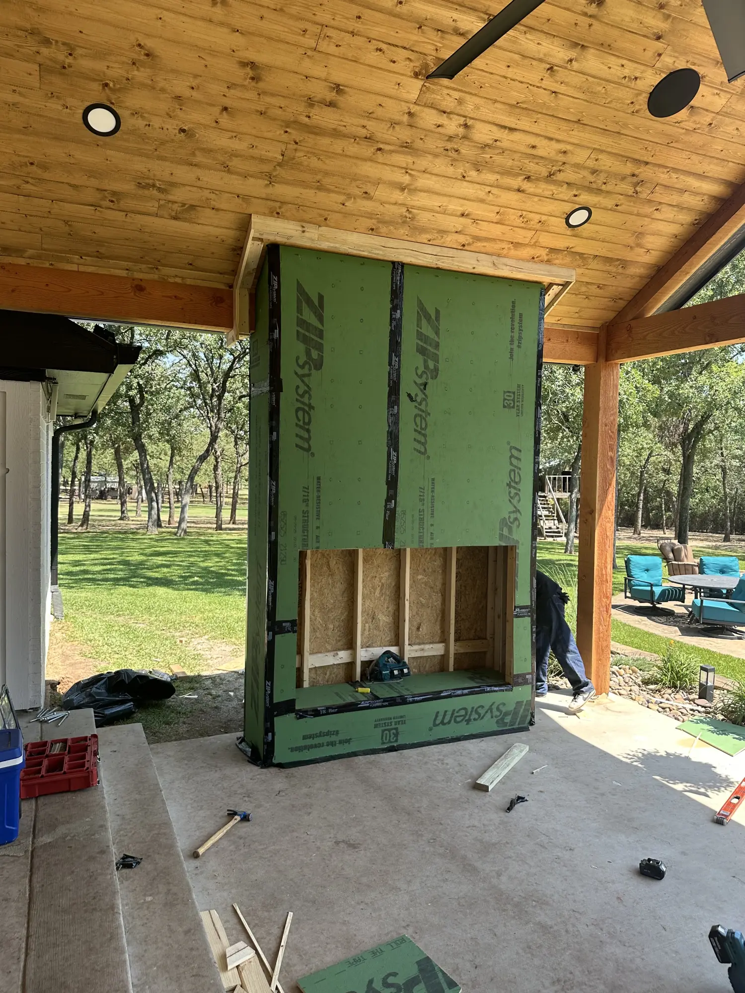 Outdoor wood fireplace feature with wood frame
